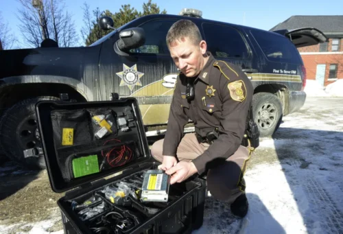 Police officer inspecting a black box for a car accident lawyer in Rock Hill, SC